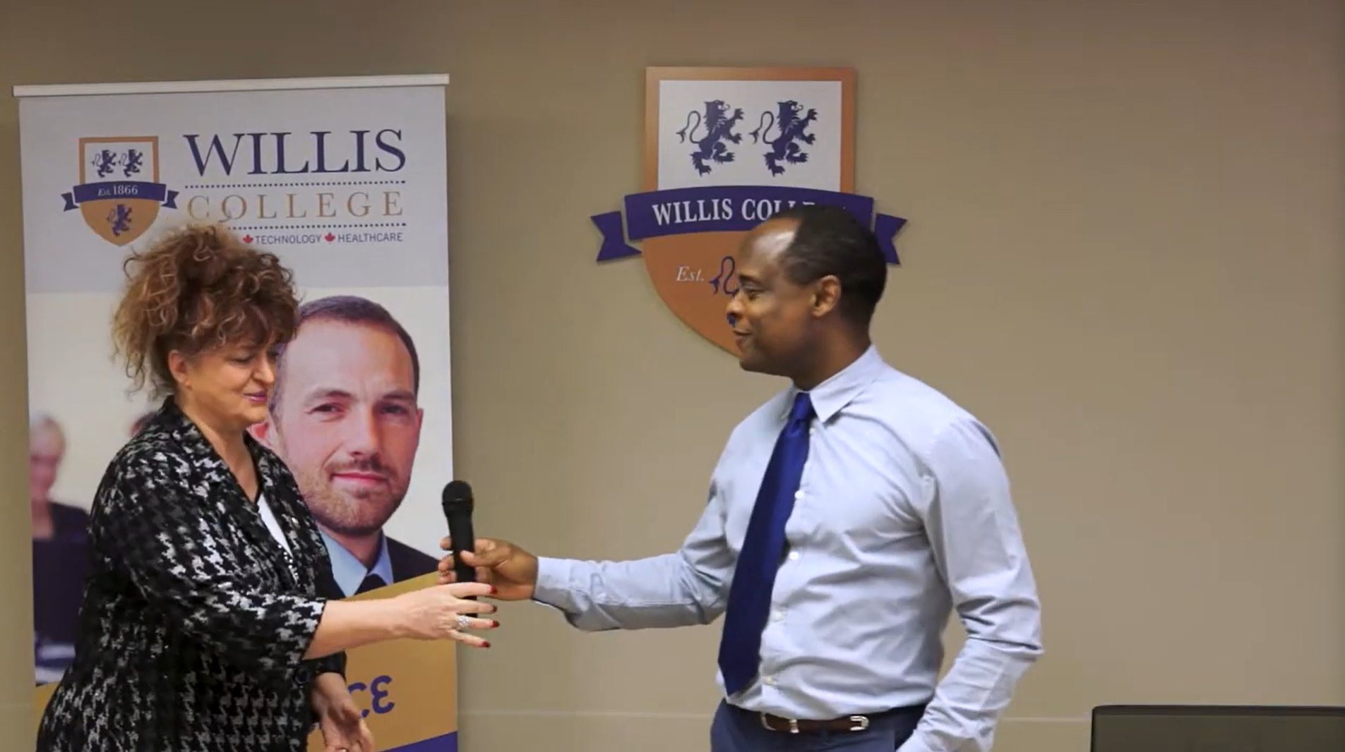 Antoine Joseph with then-president Rima Aristocrat at a Lion’s Den event at Willis College, where students presented their business plans